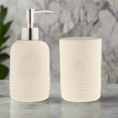 Elegant bathroom accessories: White ceramic soap dispenser and toothbrush holder set designed for modern decor.